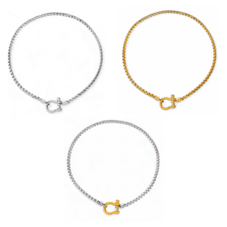 Necklace with a thick link chain and a shackle style buckle clasp pendant that is detachable, available in Gold, silver and a two toned gold-silver.