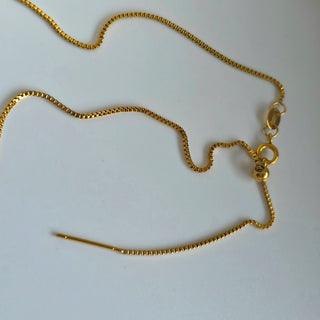 Gold chain necklace on a white background