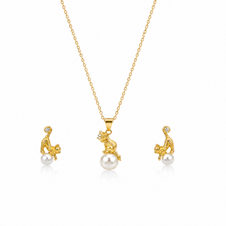 Gold jewelry set with cat and pearl pendant necklace and earrings on a white background