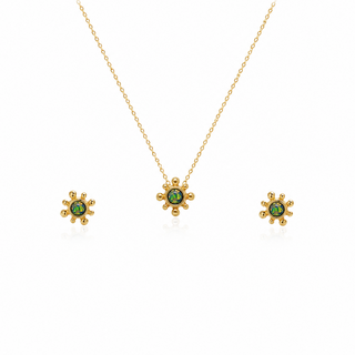 Gold necklace with green gemstones on a white background
