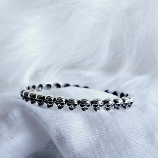 Detailed intricately carved row of skulls over the bracelet cuff in vintage style sterling silver.patinated silver