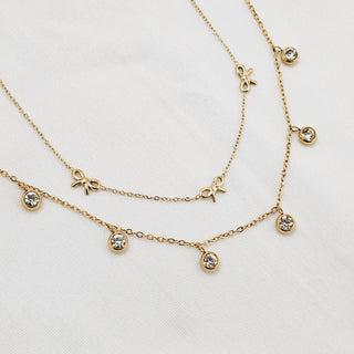 Tarnishfree 18k Gold platedon stainless steel Anklets make them waterproof thin link adjustable chain in two styles1. Bow charms and 2. Cubic zirconia charms