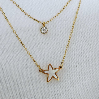Double layered thin chain necklace in 18k gold on stainless steel  tarnishfree waterproof jewellery with two pendants one of them beingmotherof pearl starfish charm and other a simple round cubic zirconia pendant.