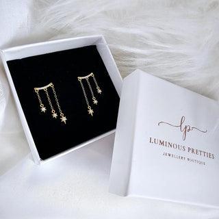 Star charm chain drop stud earrings available in SterlingSilverand 16 carat goldplated Sterling silver.