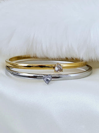 Hinged tarnishfree bangle bracelets with a raised heart shaped charm in cubic zirconia, made in 18k gold pvd plated ans sterling silver plated on stainless steel waterproof jewellery